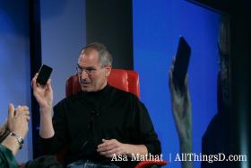 Steve Jobs holds up iPhone while talking to Walt Mossberg