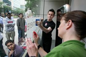 Apple employees put up window stickers at North Michigan Avenue ahead of iPhone launch | Courtesy Apple