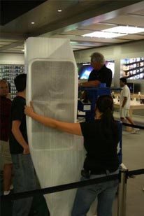 Apple Store employees guard giant iPhone display